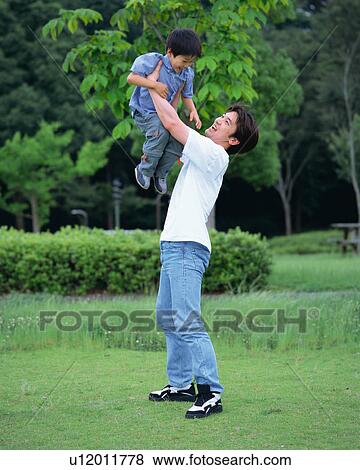 Father lifting up son View Large Photo Image Stock Photo - Father lifting up son. Fotosearch