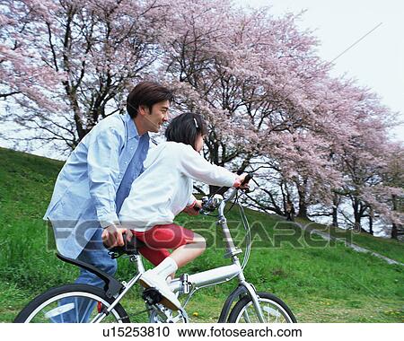 Stock Image - Girl riding a bicycle. Fotosearch