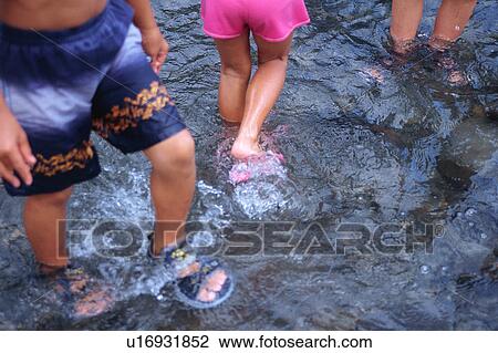 Low section of children in a river View Large Photo Image Stock Image - Low section of children in a river. Fotosearch
