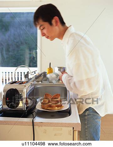 A man looking at a toaster View Large Photo Image Stock Photo - A man looking at a toaster. Fotosearch