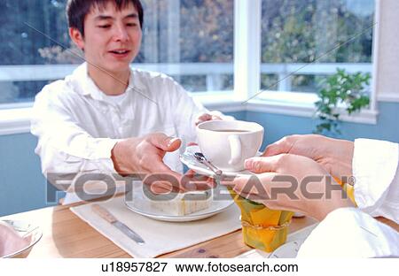 A woman serving tea View Large Photo Image Stock Photo - A woman serving tea. Fotosearch