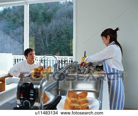 A young couple in a kitchen View Large Photo Image Picture - A young couple in a kitchen. Fotosearch