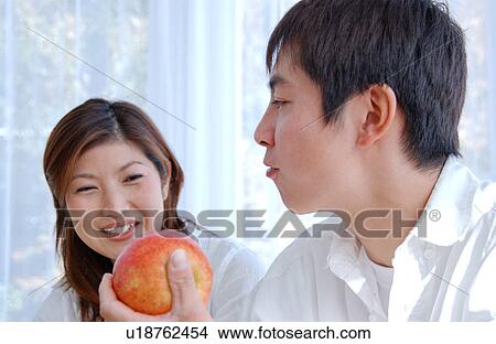 A young man eating an apple View Large Photo Image Picture - A young man eating an apple. Fotosearch