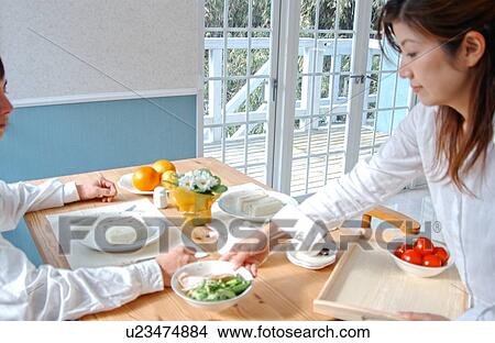 A young woman serving breakfast View Large Photo Image Picture - A young woman serving breakfast. Fotosearch