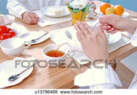 Hands of a woman serving tea View Large Photo Image Stock Photo - Hands of a woman serving tea. Fotosearch