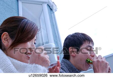 Young couple eating sandwiches View Large Photo Image Stock Photograph - Young couple eating sandwiches. Fotosearch