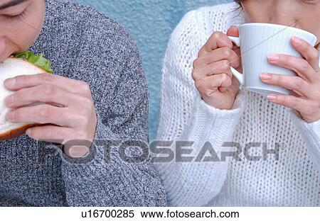 Young couple eating sandwiches View Large Photo Image Stock Photography - Young couple eating sandwiches. Fotosearch