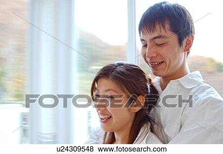 Stock Photo - Young couple embracing. Fotosearch