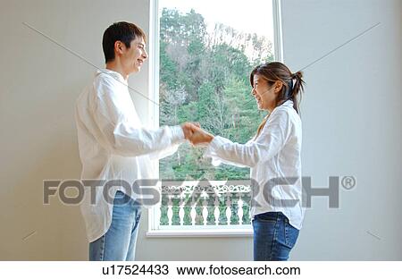 Young couple holding hands View Large Photo Image Stock Image - Young couple holding hands. Fotosearch