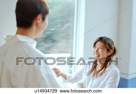 Stock Photo - Young couple holding hands. Fotosearch