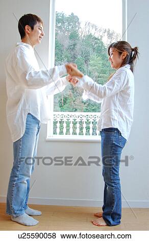 Stock Photo - Young couple holding hands. Fotosearch