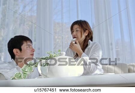 Young couple talking in a living room View Large Photo Image Stock Image - Young couple talking in a living room. Fotosearch