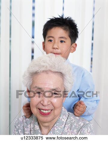 Stock Photography - A boy massaging grand mother. Fotosearch
