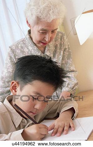 A boy studying and grand mother watching View Large Photo Image Stock Image - A boy studying and grand mother watching. Fotosearch