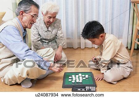 A grand father and a grand child playing with game View Large Photo Image Picture - A grand father and a grand child playing with game. Fotosearch