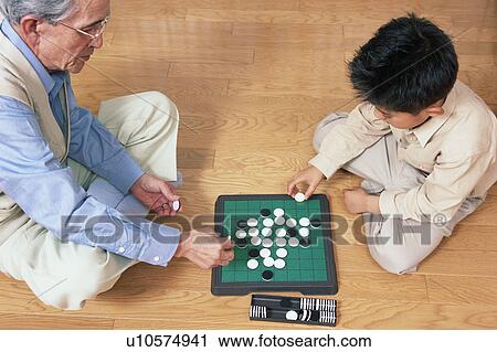 A grand father and a grand child playing with game View Large Photo Image Stock Image - A grand father and a grand child playing with game. Fotosearch