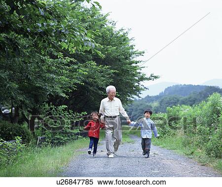 Stock Photography - A grand father walking with grand children. Fotosearch