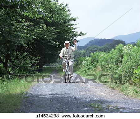Stock Photo - A senior man riding a bicycle. Fotosearch