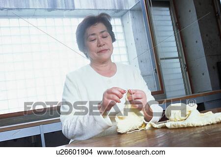 Picture - A senior woman knitting. Fotosearch