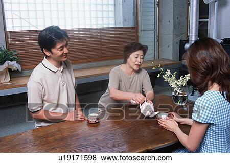 Stock Photo - A senior woman serving tea. Fotosearch