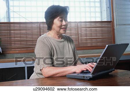 Stock Image - A senior woman using a computer. Fotosearch