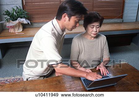 Stock Photo - A senior woman using a computer. Fotosearch
