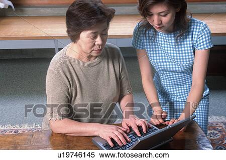 Stock Photography - A senior woman using a computer. Fotosearch
