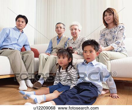 Stock Photo - Family watching TV. Fotosearch