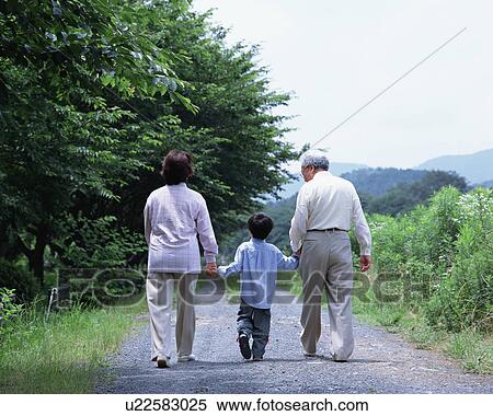 Stock Photography - Grand parents walking with a grand son. Fotosearch