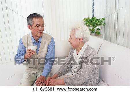 Senior couple talking in a living room View Large Photo Image Stock Image - Senior couple talking in a living room. Fotosearch