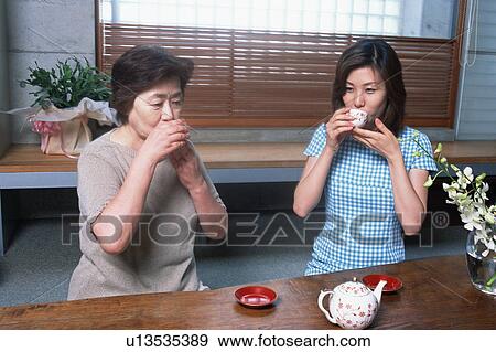 Stock Photo - Two people drinking tea. Fotosearch