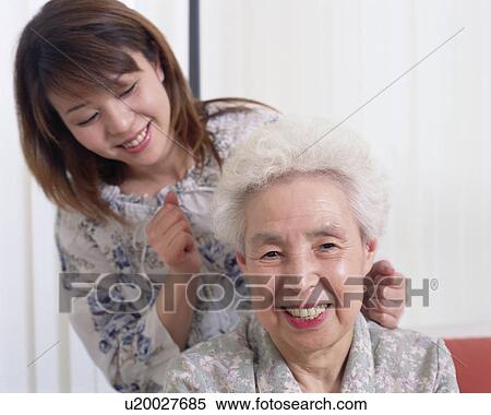 Stock Photography - A daughter giving mother massage. Fotosearch