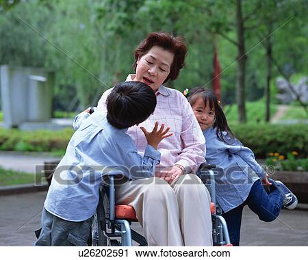 Stock Image - A grand mother and grand children. Fotosearch