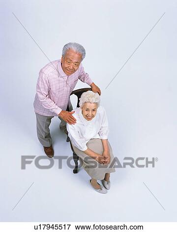A senior couple sitting in a chair View Large Photo Image Stock Photo - A senior couple sitting in a chair. Fotosearch