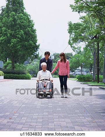 A senior man and children walking in a park View Large Photo Image Stock Image - A senior man and children walking in a park. Fotosearch