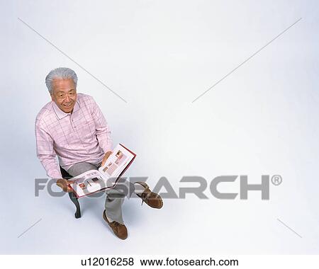 Stock Photo - A senior man reading a book. Fotosearch