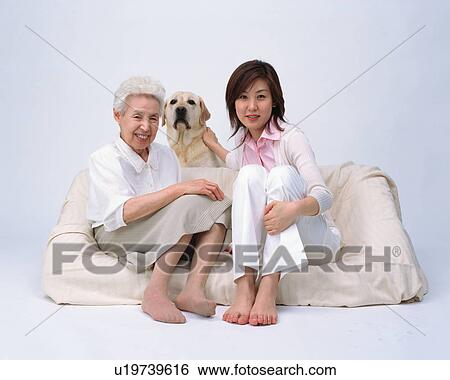 Stock Photograph - A senior woman and her granddaughter. Fotosearch