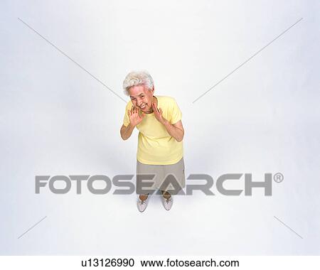 Stock Image - A senior woman calling somebody. Fotosearch
