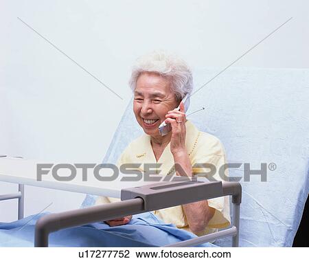 A senior woman in a bed talking with cellular phone View Large Photo Image Stock Image - A senior woman in a bed talking with cellular phone. Fotosearch