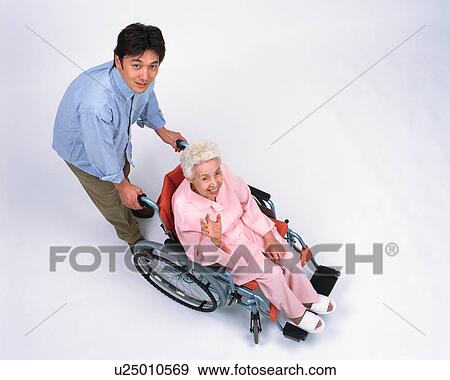 A senior woman in a wheel chair and her son View Large Photo Image Stock Photo - A senior woman in a wheel chair and her son. Fotosearch