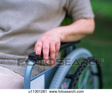 Stock Image - A senior woman sitting in a wheel chair. Fotosearch