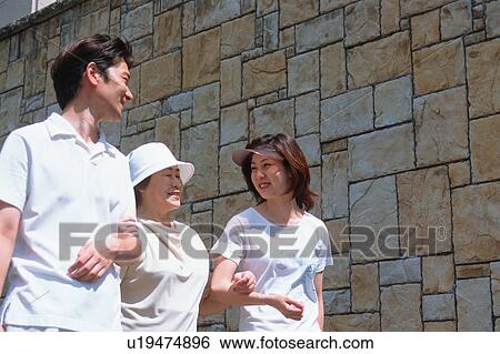 Stock Photograph - A senior woman walking with children. Fotosearch