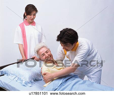 A senior woman with caretakers View Large Photo Image Stock Image - A senior woman with caretakers. Fotosearch