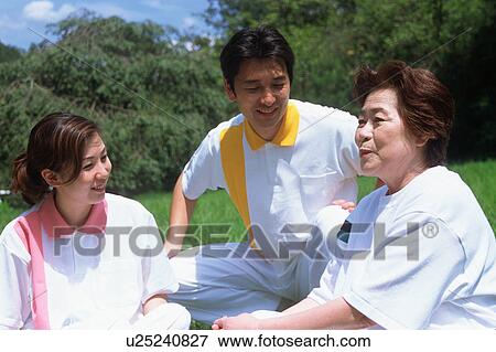 Three people talking in a park View Large Photo Image Stock Photo - Three people talking in a park. Fotosearch