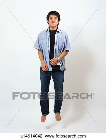 Stock Image - A young man jumping. Fotosearch
