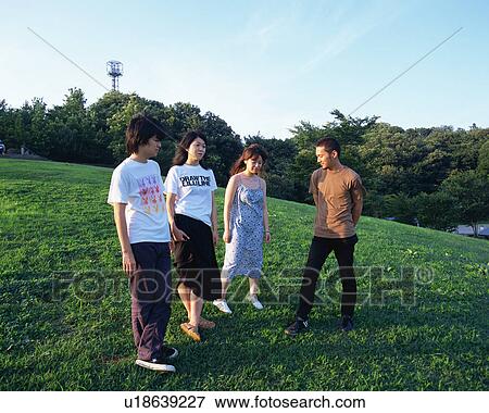 Four young people standing in fields View Large Photo Image Stock Photo - Four young people standing in fields. Fotosearch