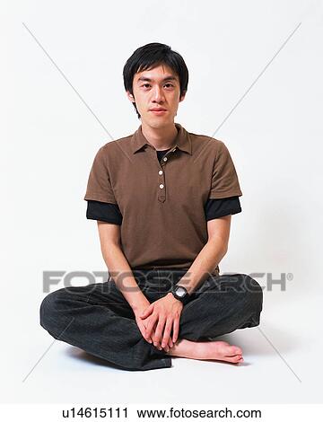 Portrait of a young man sitting with his legs crossed View Large Photo Image Stock Image - Portrait of a young man sitting with his legs crossed. Fotosearch