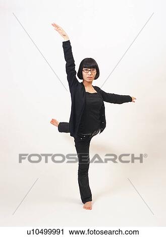 A young woman standing with one leg View Large Photo Image Stock Image - A young woman standing with one leg. Fotosearch