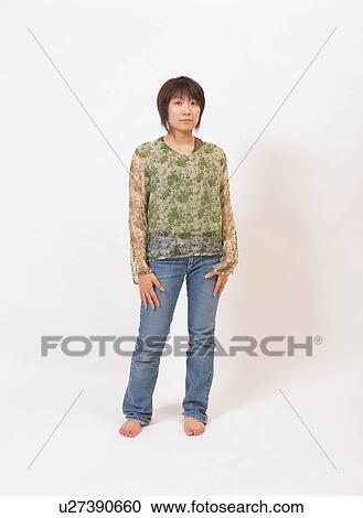 Stock Image - Portrait of a young woman standing. Fotosearch