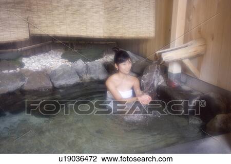 A young woman bathing in hot springs View Large Photo Image Stock Image - A young woman bathing in hot springs. Fotosearch
